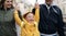 Happy family with down syndrome son outdoors on a walk in rain, having fun.