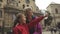 Happy family in downtown square looking away pointing to side