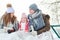 Happy family drinking tea during winter trip