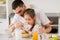 Happy family eating flakes for breakfast at home