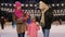 Happy family eating pancakes on skating rink