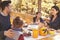 Happy family eating at table on a deck in a forest