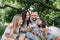 Happy family eating tasty cupcakes on picnic