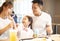 Happy family enjoying dinner in restaurant.