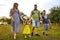 Happy family enjoying in park. Cute Portrait of Happy Family. Parents with preschool son and little daughter. Lifestyle