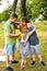 Happy family enjoying in park. Cute Portrait of Happy Family. Parents with preschool son and little daughter. Lifestyle family