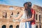 Happy family in Europe. Romantic couple in Rome over Coliseum background