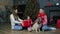 Happy family exchanging gifts for new year, parents daughter and funny pug dog celebrate