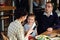 A happy family exchanging presents at a large dinner table