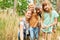 Happy family exploring forest together during summer vacation