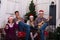 Happy family expressive singing in front of a Christmas tree