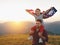 happy family father and child with flag of united states enjoying sunset