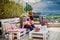 Happy family, father and kids having fun, playing together on the rooftop patio on summer day