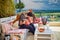 Happy family, father and kids having fun, playing together on the rooftop patio on summer day