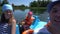 Happy family father,mother,little boy and girl sailing on boat. Gimbal selfy