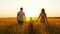 Happy family: father, mother and little son are on the wheat field, holding hands. Silhouette of a man, woman and child