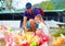 Happy family feeding colorful pigeon birds on farm