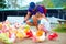 Happy family feeding colorful pigeon birds on farm