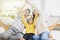 Happy family forming house roof with their hands at home