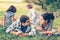 Happy family of four lying in the grass in autumn