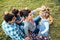 Happy family of four lying in the grass playing with apples in a