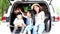 Happy family getting ready for road trip on a holiday. Happy asian children and Mother with shiba inu sitting and Sing Song in car