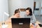 A happy family. Girl and mother are doing homework while sitting at a laptop in the room. Mom teaches daughter sitting