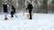 Happy family with Golden Retriever dog having fun in winter park playing with snow