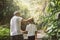 Happy family grandfather and granddaughter walk on nature on sunset hold hand.