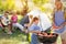 Happy family grilling meat on a barbecue