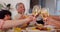 Happy family, hands and toast for Christmas dinner celebration together with meal or support. Cheers closeup, wine glass