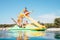 Happy family hands up on floating Playground slide Catamaran as they enjoying sea trip durins summer vacation