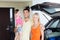 Happy family with hatchback car at home parking