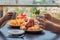 Happy family having breakfast on the balcony. Breakfast table with coffee fruit and bread croisant on a balcony against