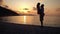 Happy family having a fun at beach at sunset over the sea. Slow molion footage