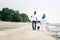 Happy family having fun time walking together at the beach located in Pantai Remis