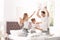 Happy family having pillow fight on bed