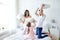 Happy family having pillow fight in bed at home