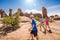 Happy family hiking together in the beautiful rock formations of Arches National Park