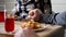 Happy family holding hands and praying with closed eyes before having a meal. Caucasian christians parents with small