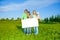 Happy family holds white square paper format