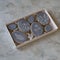 Happy family holiday, presents in box , gingerbread easter gray cookies in form eggs with floral pattern. Festive cookies in white
