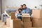 Happy family with kid embracing on sofa enjoying moving day
