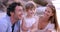 Happy family, kid and parents tickle at beach on vacation, summer holiday and travel outdoor. Funny mother, father and