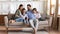 Happy family with kids relax on couch using cell
