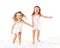 Happy family . kids twin sisters jumping on the bed, playing an