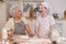 Happy family in kitchen. Grandmother and granddaughter child cook in kitchen together. Grandma teaching kid girl knead