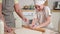 Happy family in kitchen. Grandmother and granddaughter child cook in kitchen together. Grandma teaching kid girl roll