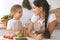 Happy family in the kitchen. Mother and child daughter make menue for cooking tasty breakfest in the kitchen. Little