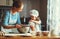 Happy family in kitchen. mother and child preparing dough, bake